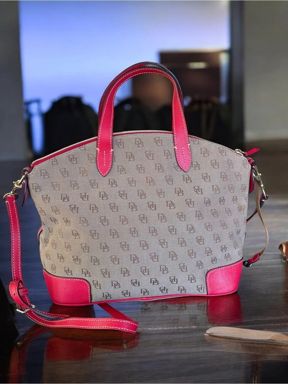 Dooney & Bourke Signature monogram satchel features vibrant pink leather trim